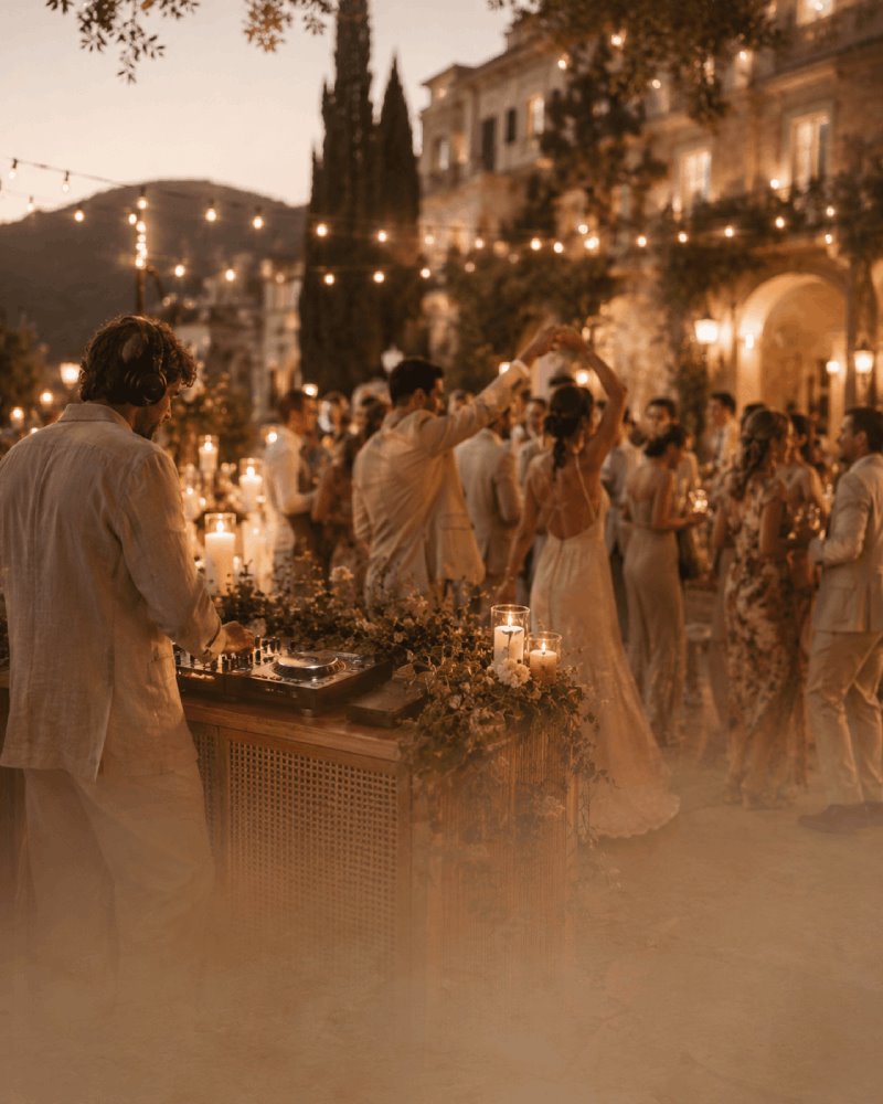 DJ and entertainment at a candlelit outdoor wedding reception